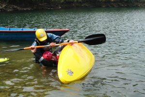 Nim teaching a beginner how to kayak on Phewa Lake during the first Paddle Nepal kayak clinic