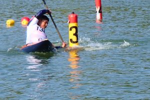 Nim Bahadur Magar paddles an ICF kayak around an obstacle slalom pole during the canoe slalom competition at the 2014 Asian Games in Incheon, South Korea.