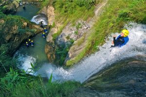 Canyoning with Paddle Nepal.  Abseiling, cliff jumping, natural sliding and swimming while exploring waterfalls in the remote jungle between Pokhara and Chitwan