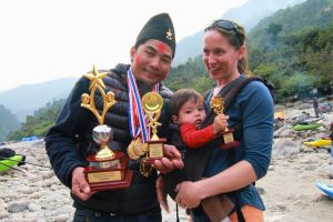 Nim Bahadur Magar celebrating another win at Himalayan Whitewater Challenge with his son Kailash and wife Kelly
